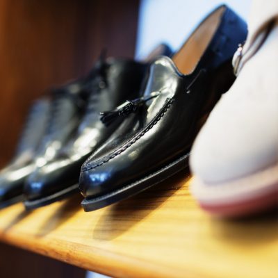 Formal shoes arranged in shelf at clothing store